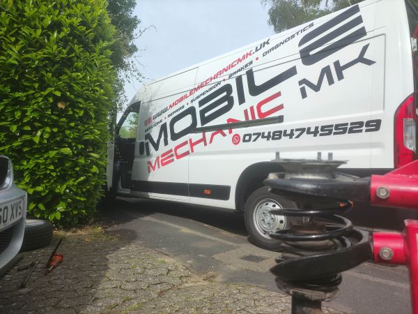 Mobile mechanic changing coil spring on a BMW in Milton Keynes